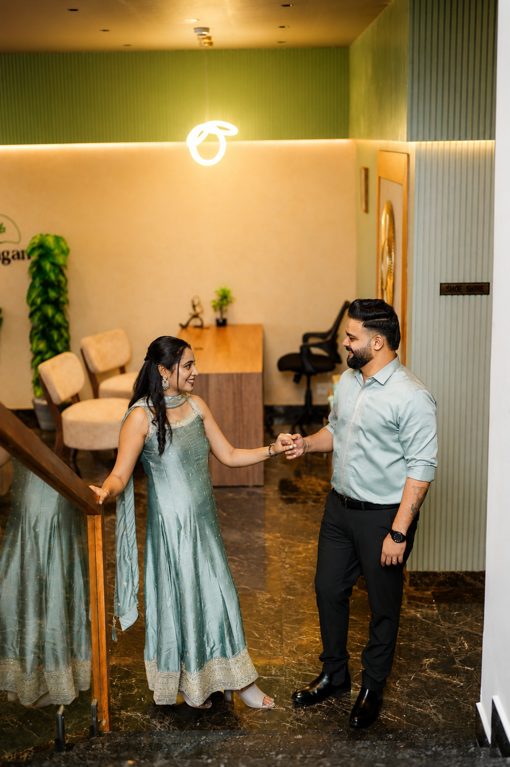 Sintomon and Sona laughing together in an elegant interior space